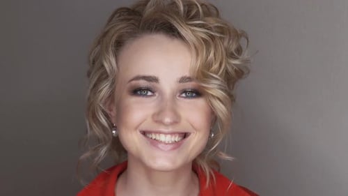 Radiant Blonde Woman Smiling in Close-up