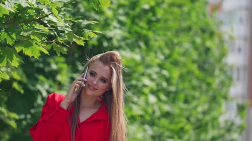 Woman Talking on Smartphone Outdoors