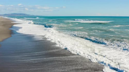 Ocean waves splash into the sand