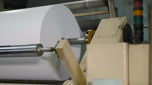 Roll of White Paper on Machine in Factory