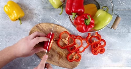 Slicing Fresh Red Bell Pepper on Cutting Board