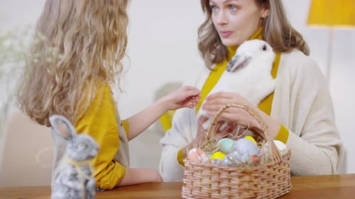 Child with Rabbit and Easter Eggs at Home