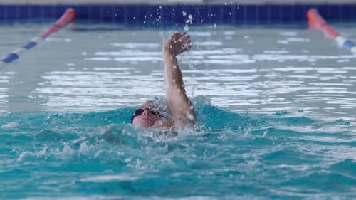 Swimmer swimming into the pool