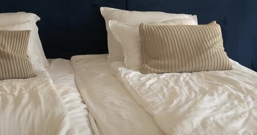 Man Lies Down on Bed to Rest