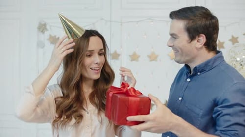 Loving Couple Celebrating a Birthday with a Gift
