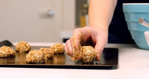 Woman placing dough on baking tray