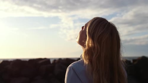 Female Photographer Using Slr Camera On Beach