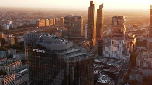 Slide and Pan Footage of Top of Modern Tall Commercial Building with Glossy Glass Facade