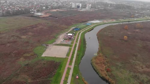Modern quay with sports and recreation areas along small river, Promenade with relaxing spaces