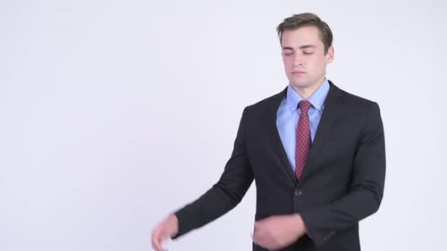 Smiling Man Presents to the Side in Studio