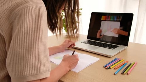 Woman Learning to Draw Using Laptop