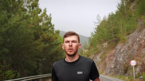 Man Running on Scenic Mountain Road