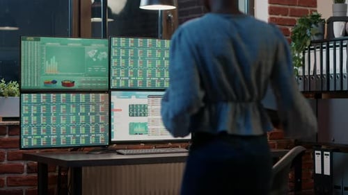 Female Analyst Looking at Exchange Market Statistics on Laptop