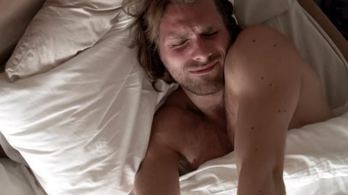 Top View of Man Waking Up and Stretching