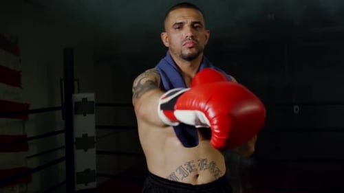 Athletic Boxer Warming Up in Boxing Ring