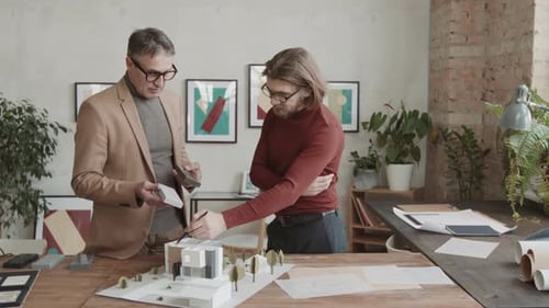 Male Architects Choosing Building Material For New House
