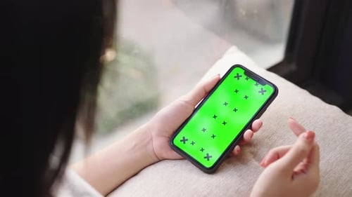 Top view chroma key smartphone technology, cell phone scrolling by hand concept.