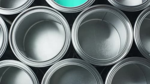 Open Cans of Paint on a Black Background. Green Color