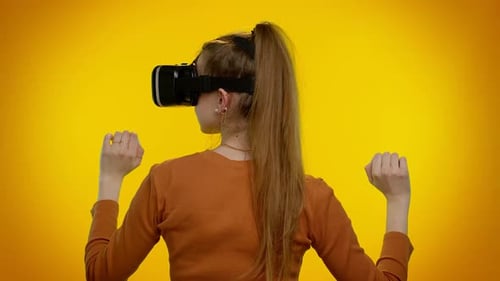 Woman Using Virtual Reality Headset on Yellow Background