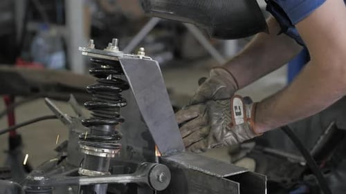 Welding Process. Welder In Helmet Works, Worker Works In The Auto Workshop