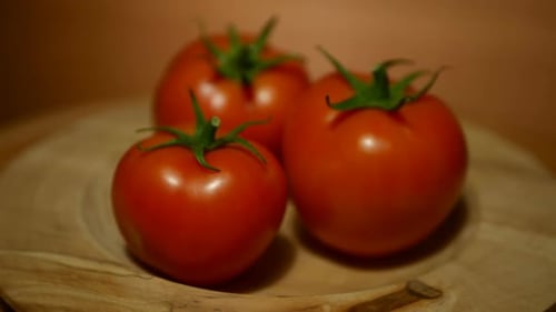 Ripe Red Tomatoes on a Wooden Plate