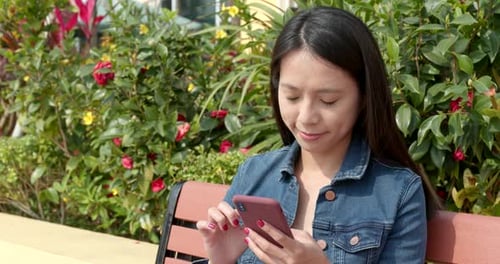 Woman use of mobile phone at outdoor park