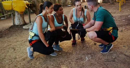 Young Adults Preparing for Zip Lining Adventure