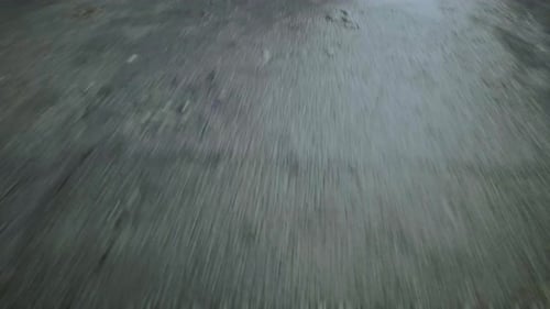 Closeup Cinematic POV Shot of an Wet Asphalt Road