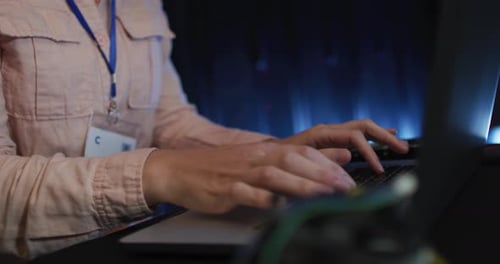 Mid section of caucasian female it technician typing on laptop