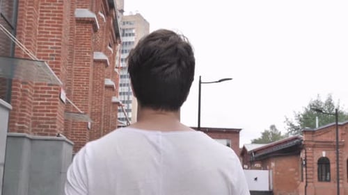 Back View of Casual Man Walking on Street