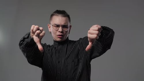 Young Adult Giving Thumbs Down Gesture
