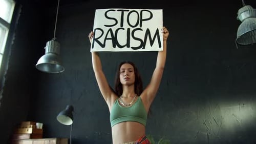Woman Holds Anti-Racism Sign Upright