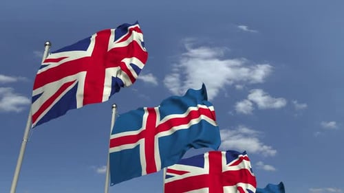 Realistic Waving Flags of Iceland and United Kingdom Against Blue Sky