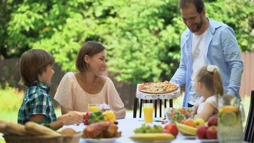 Family Celebrates Birthday With Food Outdoors