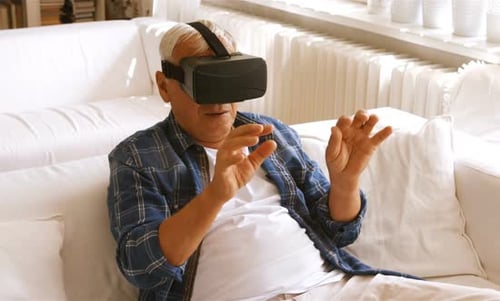 Senior Man Experiencing Virtual Reality Headset on Couch