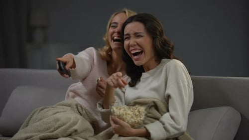 Two Young Beautiful Woman Watching Comedy and Laughing Loudly, Funny Movie