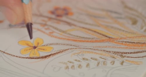 Close up of an artist drawing with colored pencils