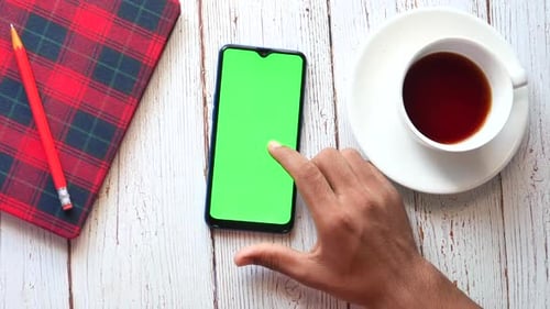 Top View of Man Hand Using Smart Phone on Office Desk