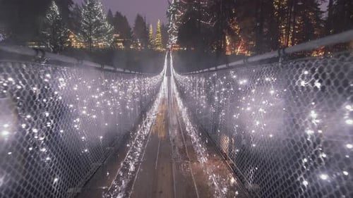 Long Suspension bridge decorated with Christmas lights, Rainy night