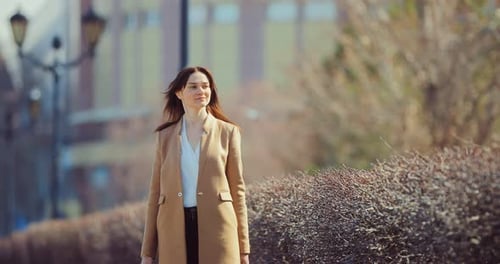 Pretty Business Lady Walks on Park Paths in Early Spring Birds Fly
