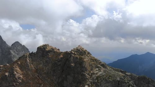 AERIAL Mountain Summit Dolly Out revealing beautiful mountain range landscape and epic view