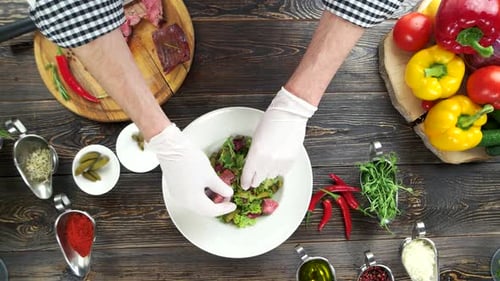 Chef Prepares Gourmet Meat Salad Overhead