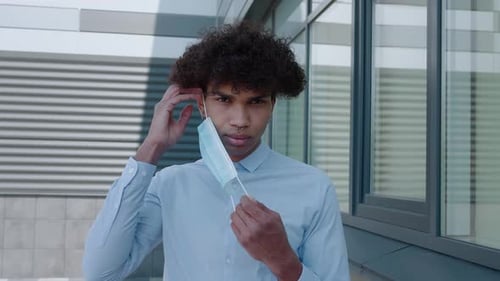African Black Man Putting on Outbreak Mask Prevention Young Man Wearing Covid Mask