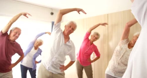 Seniors Stretching With an Instructor