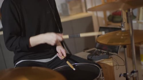 Guy In Headphones Playing Drums