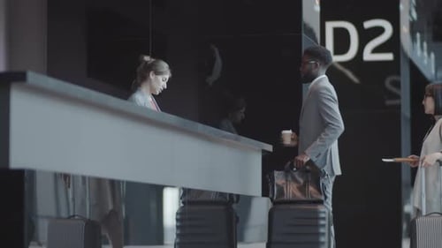 Cheerful Afro-American Man in Suit Checking In at International Airport