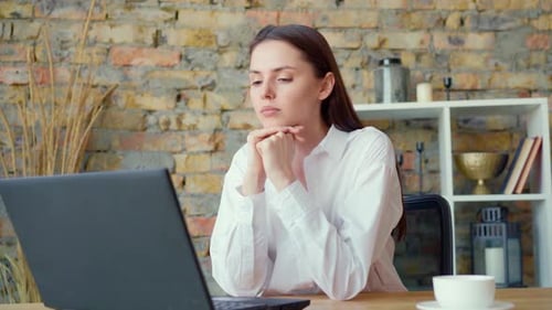 Confident Smiling Businesswoman Having a Video Conversation in Office