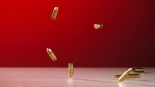 Falling Golden Bullets on Red Background