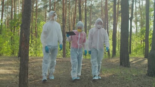 Scientists in Biohazard Suits Examining Level of Radiation