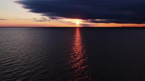 Dark Sea with a Light Ray Against the Background of the Sunset